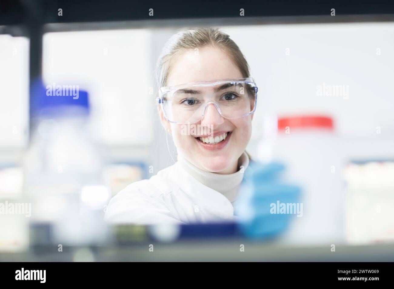 Junger Wissenschaftler lächelt im Labor Stockfoto