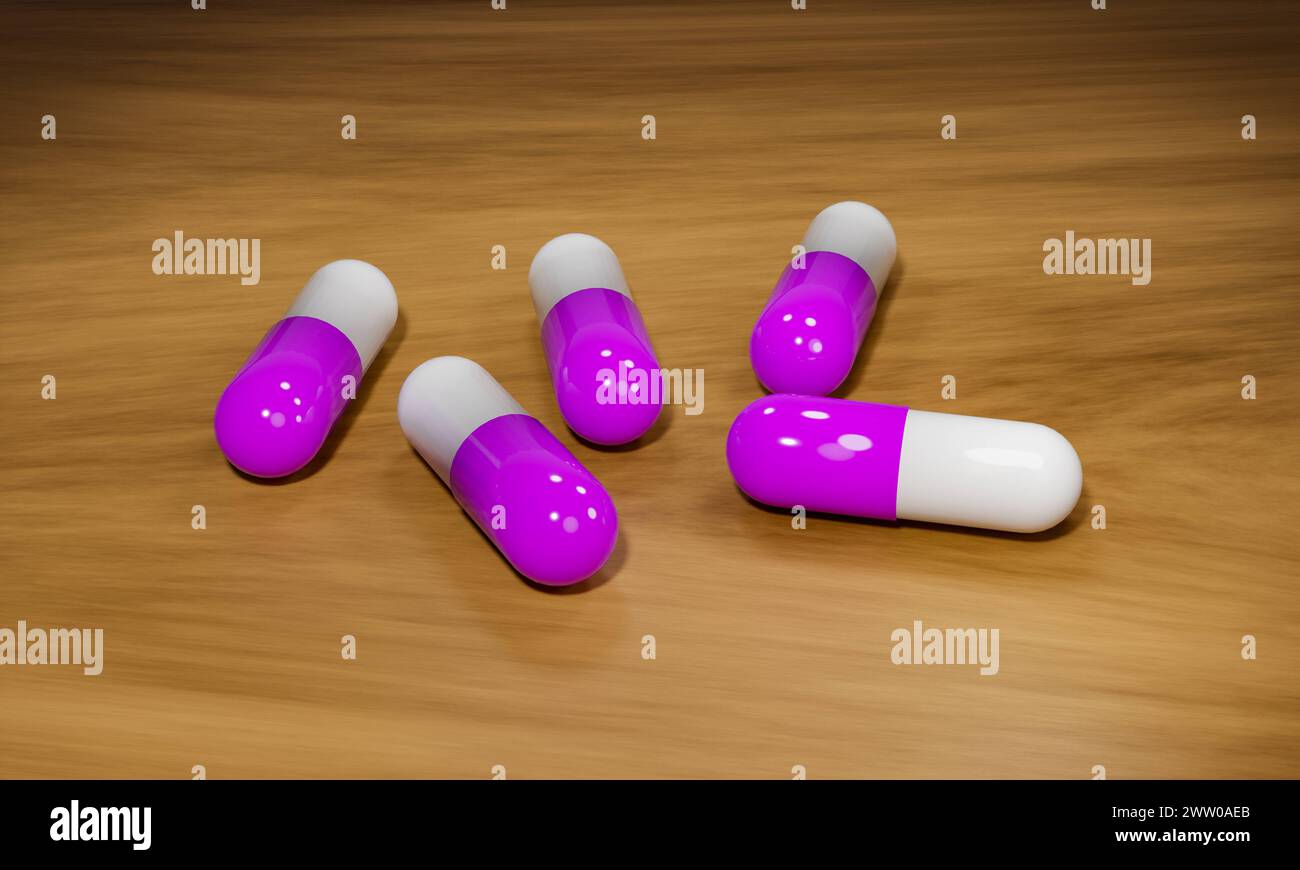 Rosafarbene Heilpillen auf einem Holztisch. Rosafarbene Kapseln, medizinische Pillen auf einem Holztisch. Industrielle Herstellung von Medikamenten, Antibiotika oder anderen Medikamenten. S Stockfoto