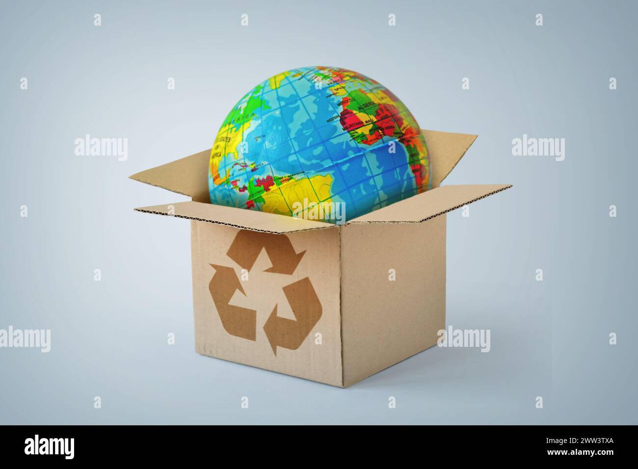 Planet Erde im Karton mit Recycling-Symbol - Konzept der Ökologie und weltweite Lieferung Stockfoto