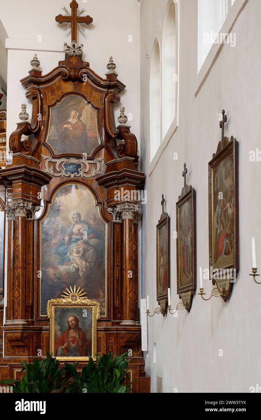 Wien, Österreich. Kirche der Heiligen Maria der Engel (Kapuzinerkirche). Seitenaltar mit Gemälden von Maria, Josef und Jesuskind Stockfoto