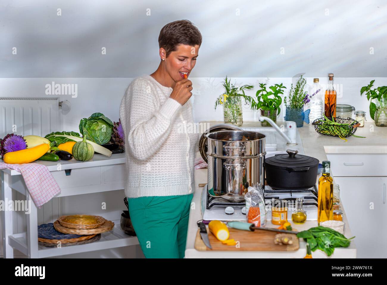 Eine Frau, die das Grusel der gedämpften Karotte schmeckt. Stockfoto