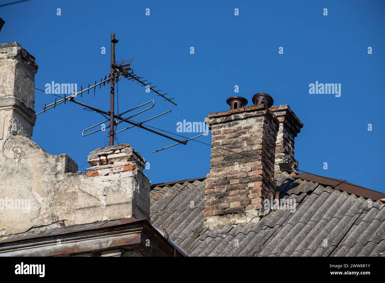 Alt und mit Moos bedeckt, bedecken wellige Dachschieferplatten die Scheune. Stockfoto