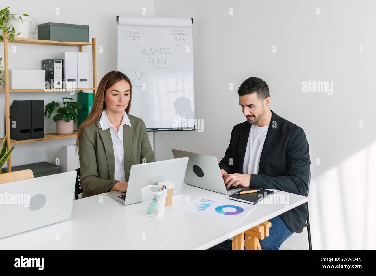 Geschäftsleute, die mit einem Laptop am Schreibtisch arbeiten Stockfoto