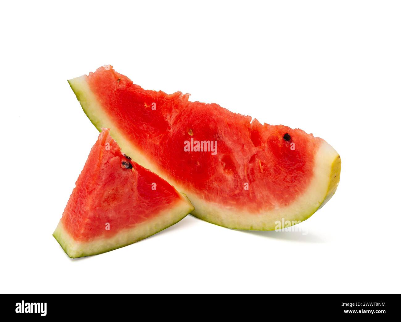 Schneiden Sie rote reife Wassermelone mit grüner Schale in kleine Stücke unterschiedlicher Größe mit schwarzen Samen auf weißem Hintergrund. Professionelles Studio-Makrofoto Stockfoto