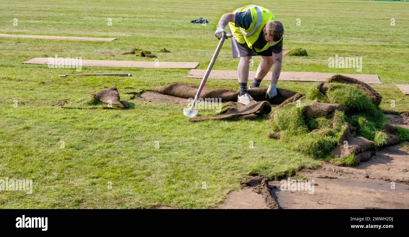 Mann, der in einem Park Rasen legt Stockfoto