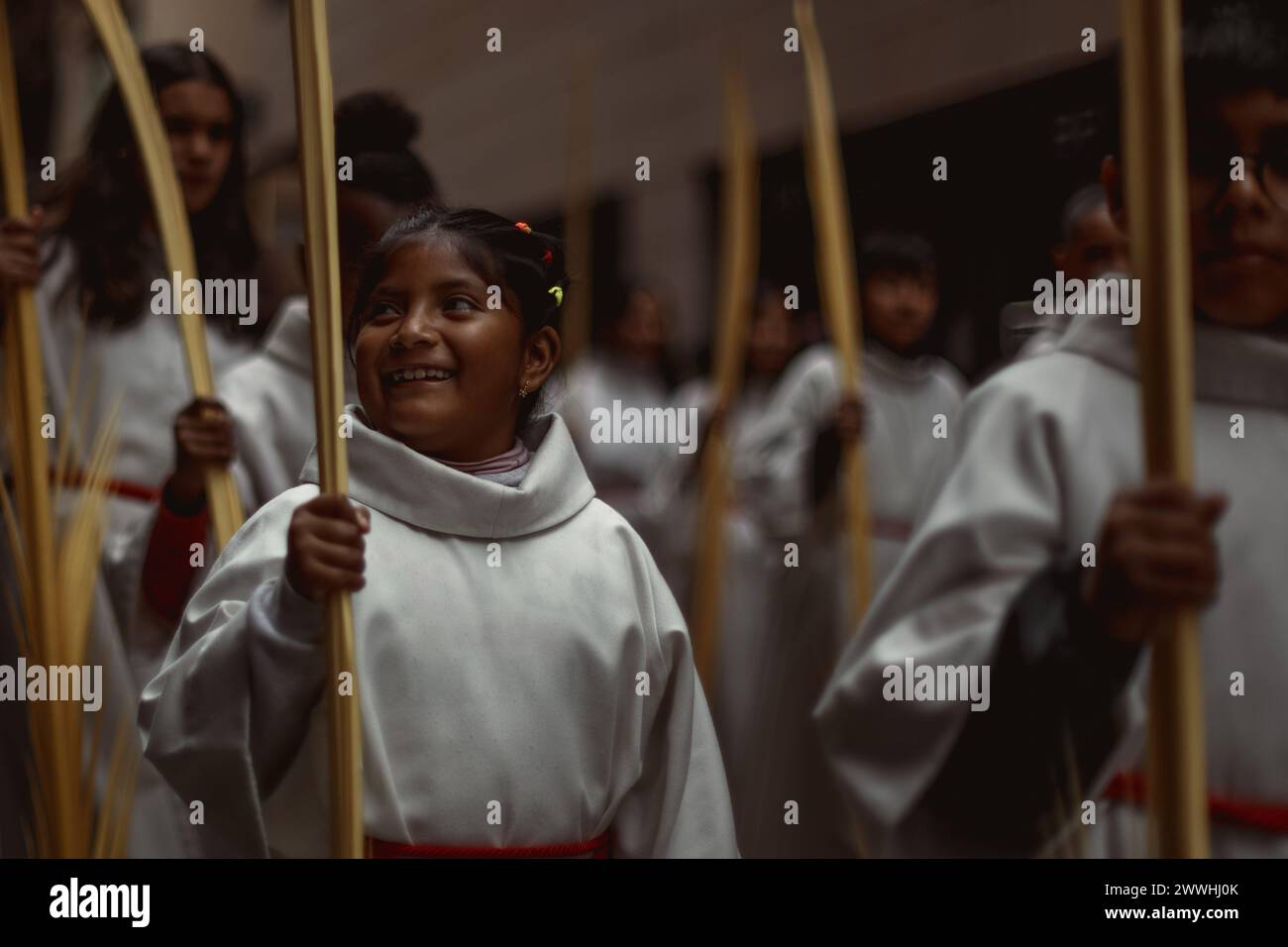 Barcelona, Spanien. März 2024. Junge Pönitenten aus der 'Gran Poder und Macarena Esperanza'-Bruderschaft gehen während der Palmensonntagsprozession in Barcelona mit Palmenzweig durch die Straße. Credit: Matthias Oesterle/Alamy Live News Stockfoto