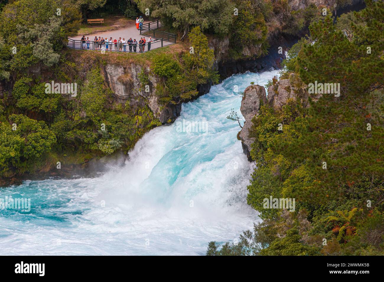 Eine Gruppe von Menschen, die sich die Huka Falls ansehen, eine Reihe von Wasserfällen am Waikato River, der den Lake Taupo entwässert, auf der Nordinsel in Neuseeland. Stockfoto