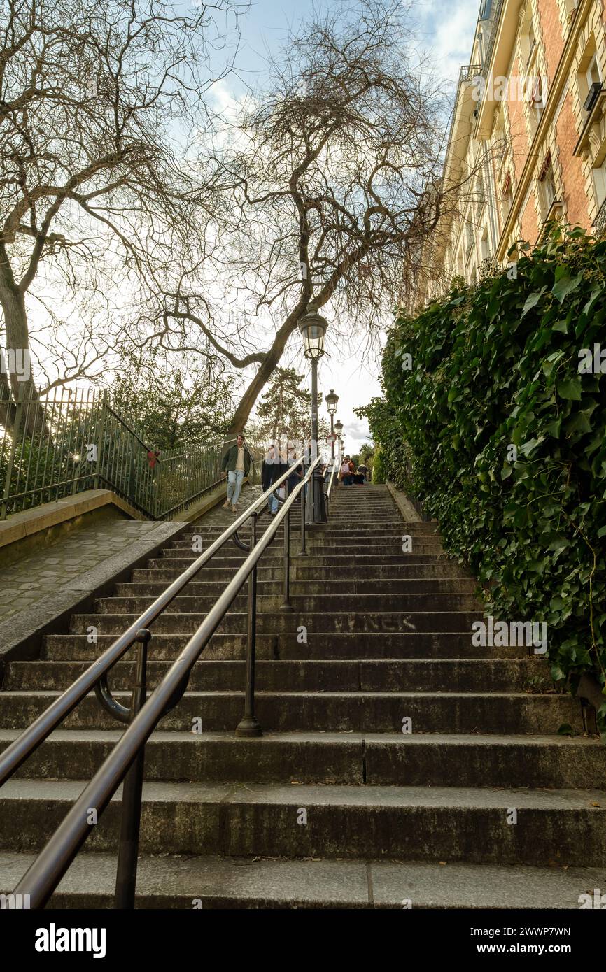 Paris, Frankreich - 17. Februar 2024 : Blick auf Touristen, die die malerischen Treppen mit Pariser Laternen in Montmartre Paris Frankreich hinauf und hinunter laufen Stockfoto