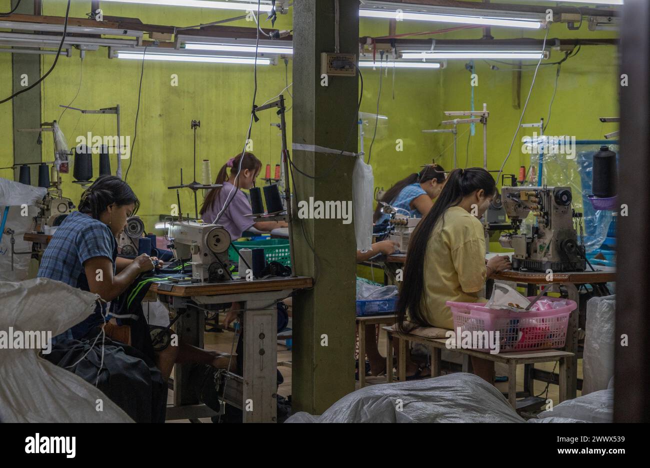 Illegale burmesische Einwanderer arbeiten in einer kleinen Textilkleiderei in Mae SOT, Thailand Stockfoto