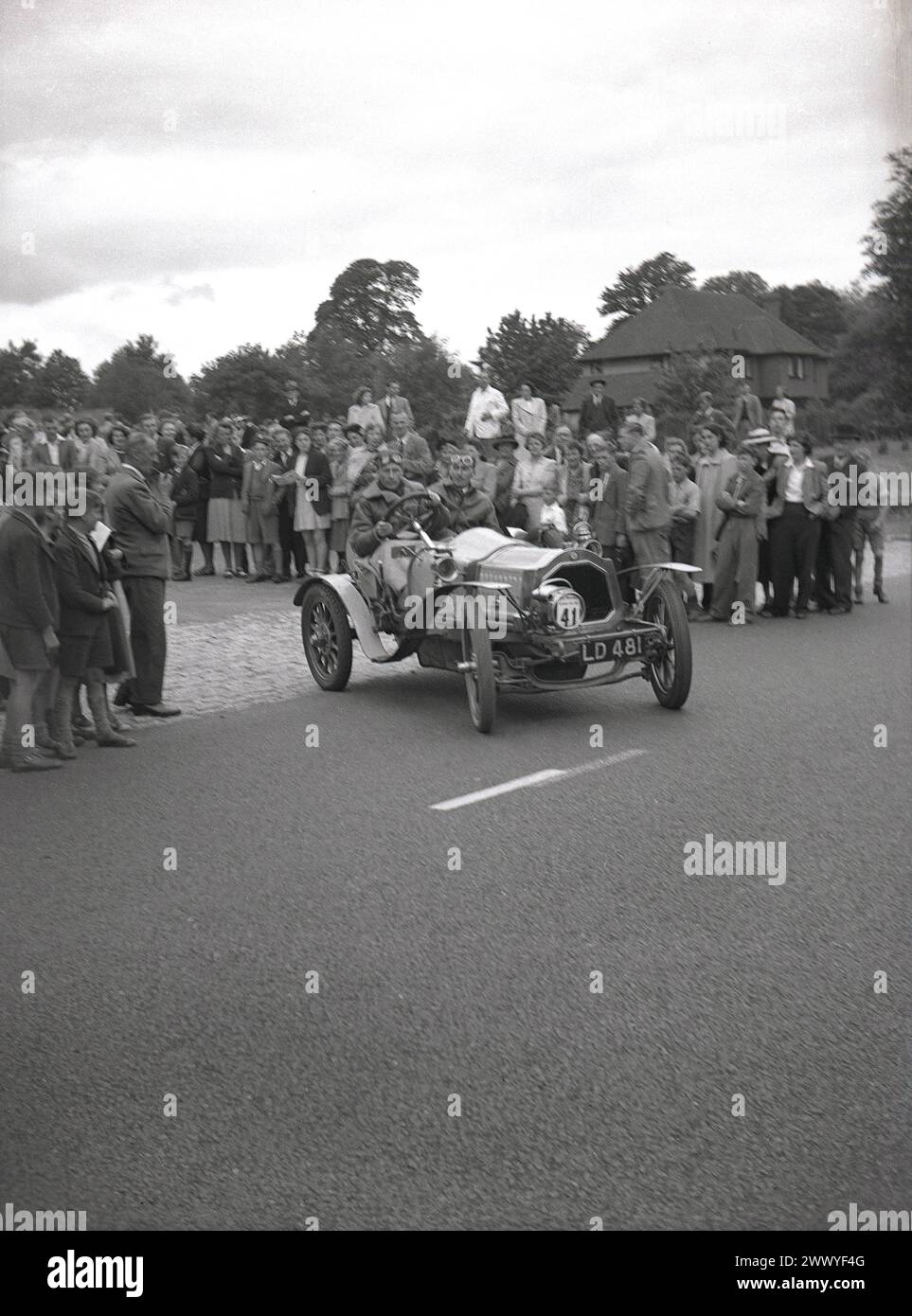 1950er Jahre, historisch, eine Menschenmenge, die einen Oldtimer beobachtet, Nr. 39, Autokennzeichen LD 481, ohne Dach oder Türen - fahren Sie auf einem Oldtimer-Lauf, England, Großbritannien. Autos, die vor dem 1. Weltkrieg gebaut wurden, gelten allgemein als Veteranenwagen, obwohl die strenge Interpretation besagt, dass nur Fahrzeuge, die vor 1904 gebaut wurden, als Veteranenautos bezeichnet werden können und dass Autos, die zwischen 1905-1918 gebaut wurden, als Edwardianische Autos bezeichnet werden sollten. Autos, die zwischen 1919 und 1930 hergestellt wurden, werden im Allgemeinen als Vintage klassifiziert. Stockfoto