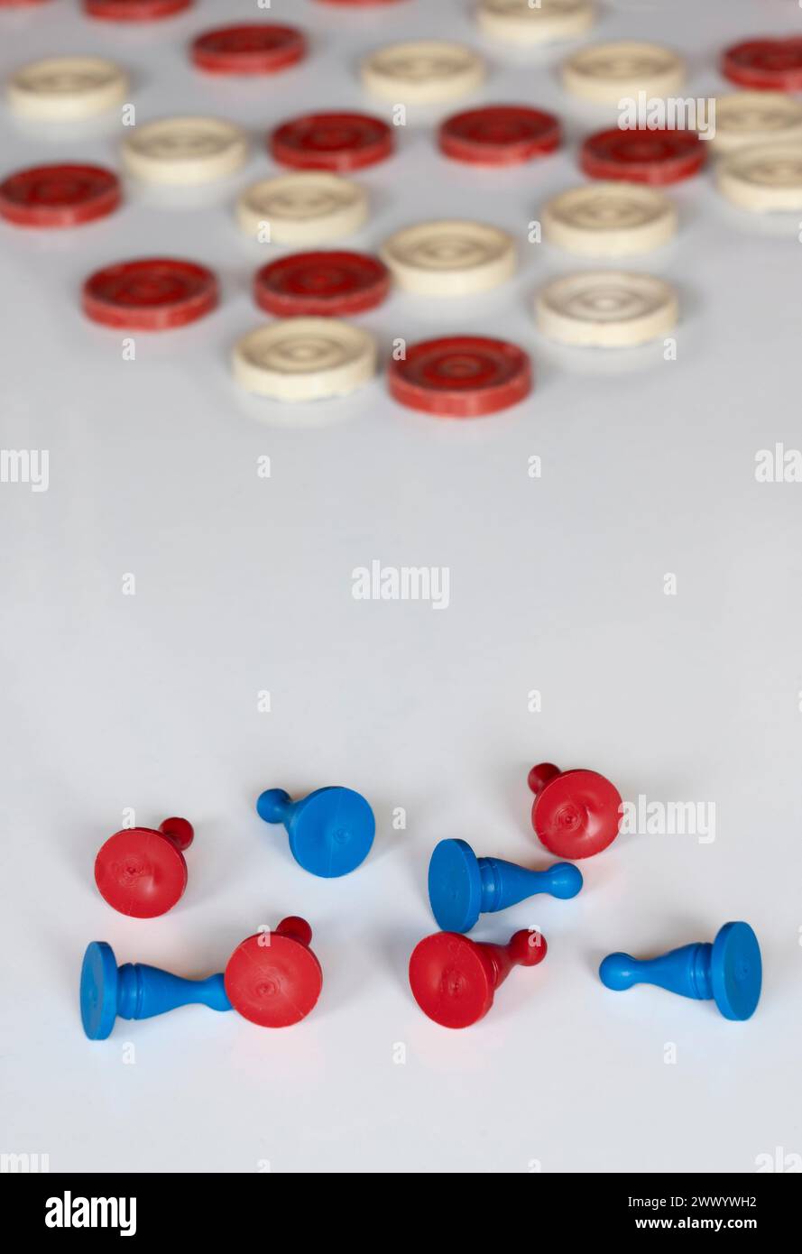 Altes und neues Spiel, Schachfiguren und Spielsteine in Rot, Blau und weiß. Teams, Gegner, Herausforderung und Kampf um einen Sieg. Gibt es einen Gewinner oder ein Team? Stockfoto