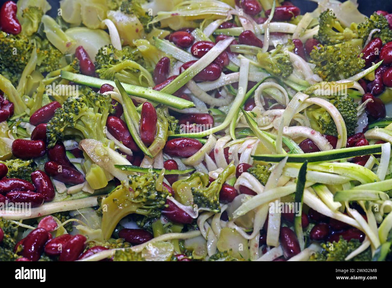 Gemüseküche ohne Fleisch Brokkoli, Zuccini und Kidneybohnen während der Zubereitung in einer Bratpfanne *** Gemüseküche ohne Fleisch Brokkoli, Zucchini und Kidneybohnen während der Zubereitung in einer Bratpfanne Stockfoto