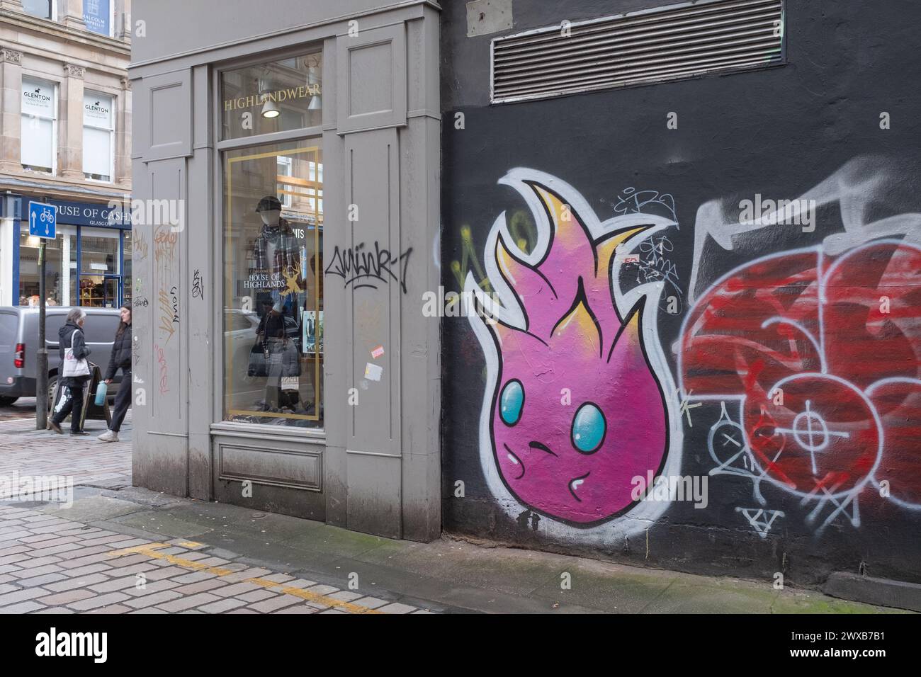 Ein Wandgemälde und Graffiti in einer Gasse an der Gordon Street, Glasgow Stadtzentrum, Schottland. Dies ist ein belebter Einzelhandelsbereich voller Geschäfte und anderer Geschäfte. Stockfoto