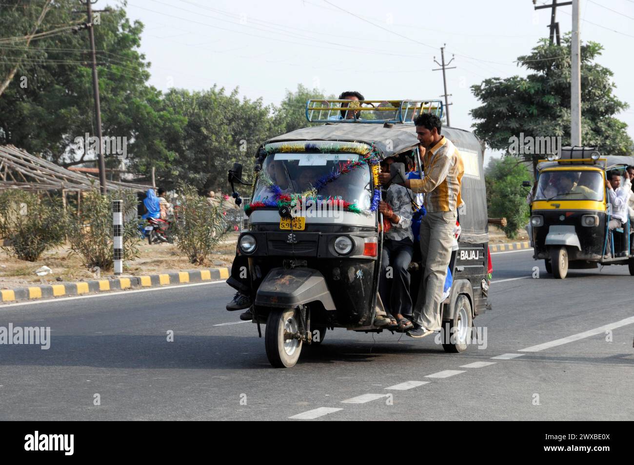 Ein Tuk-Tuk mit Passagieren auf einer belebten Straße als alltägliches Transportmittel, Rajasthan, Nordindien, Indien Stockfoto