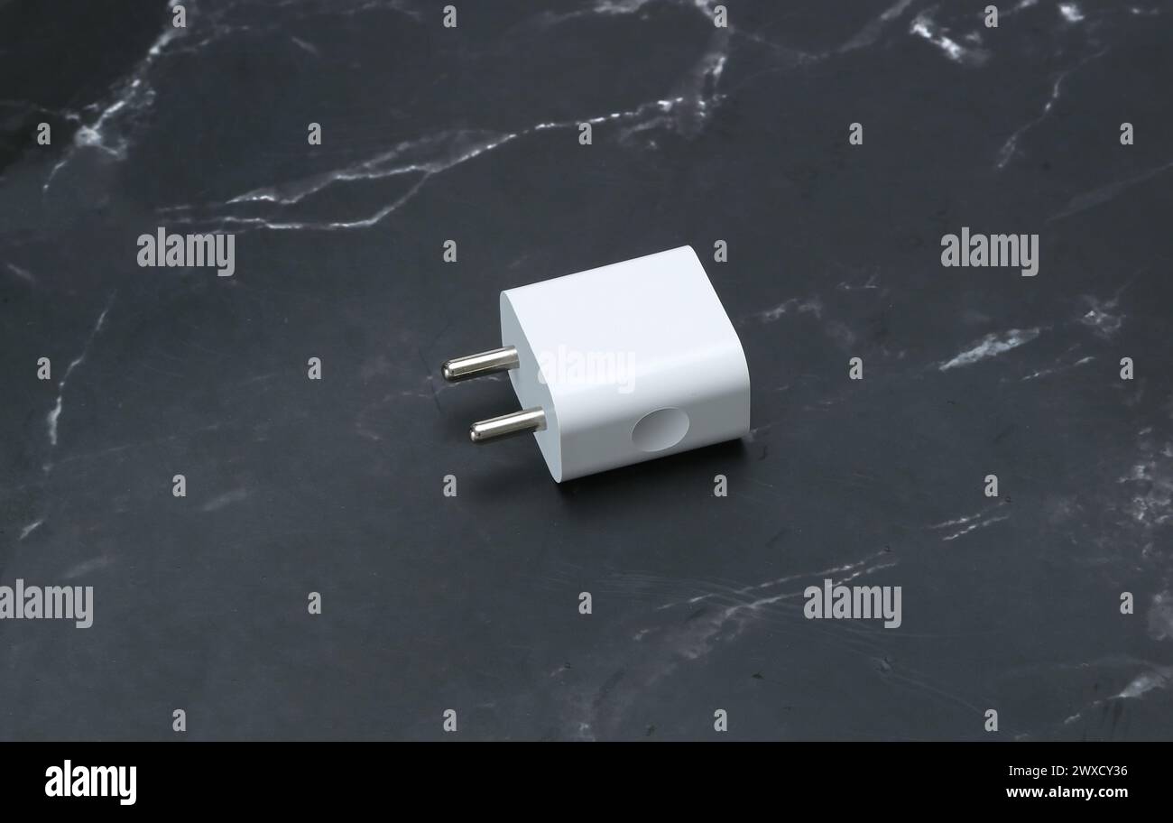 Zwei-Pin-Smatphone weiße Farbe Ladegerät isoliert auf schwarzem Marmorhintergrund Stockfoto