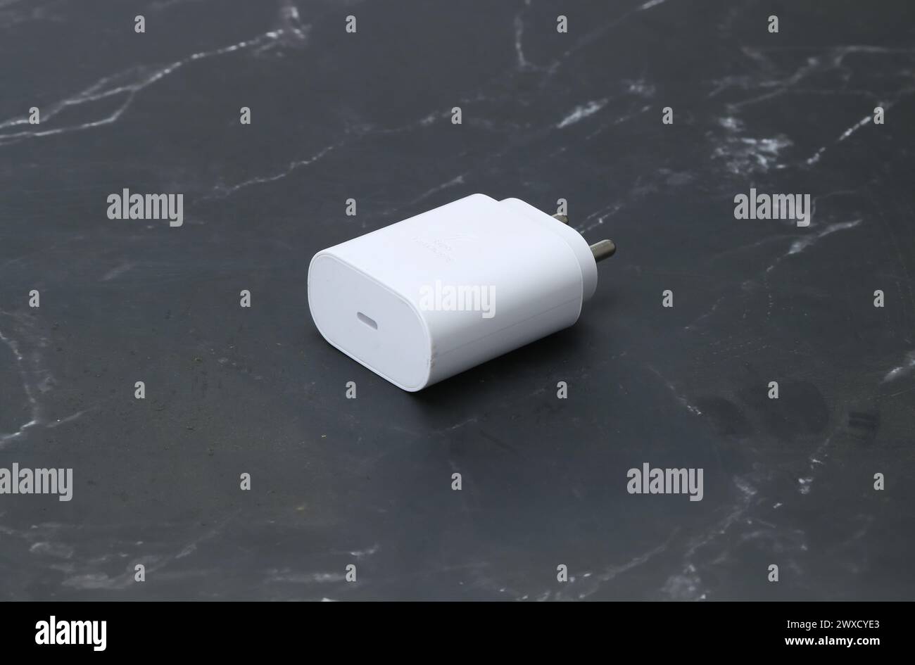 Zwei-Pin-Smatphone weiße Farbe Ladegerät isoliert auf schwarzem Marmorhintergrund Stockfoto