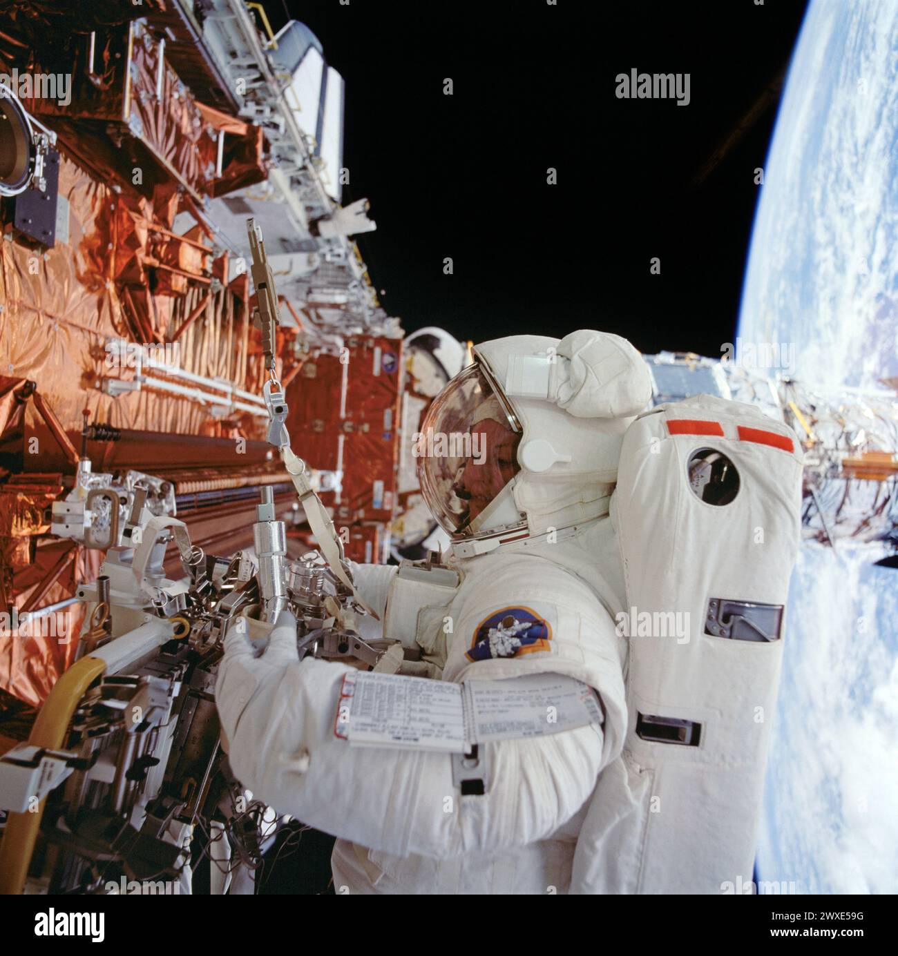 Astronaut Kathryn Thornton arbeitet am Hubble-Weltraumteleskop Astronaut Kathryn C. Thornton arbeitet mit Ausrüstung, die während des vierten Raumwanderns auf der 11-tägigen Mission mit der Wartung von Arbeiten am Hubble-Weltraumteleskop verbunden ist. 19. Dezember 1993. Eine optimierte Version eines Originalbildes der NASA. NUR REDAKTIONELLE VERWENDUNG. Obligatorische Gutschrift: NASA Stockfoto