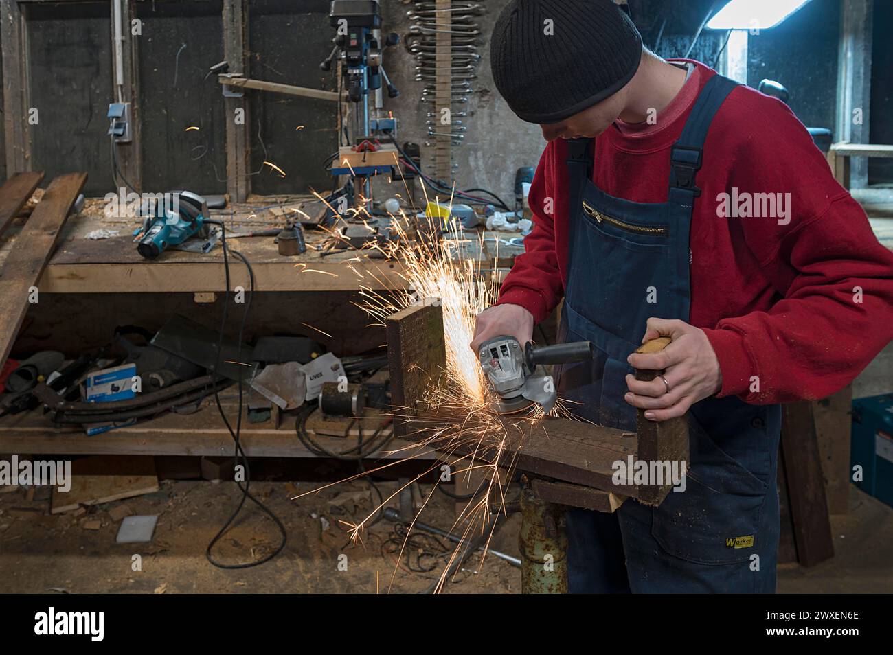 Junger Mann bei einem FLEX in seiner Werkstatt, Mecklenburg-Vorpommern Stockfoto