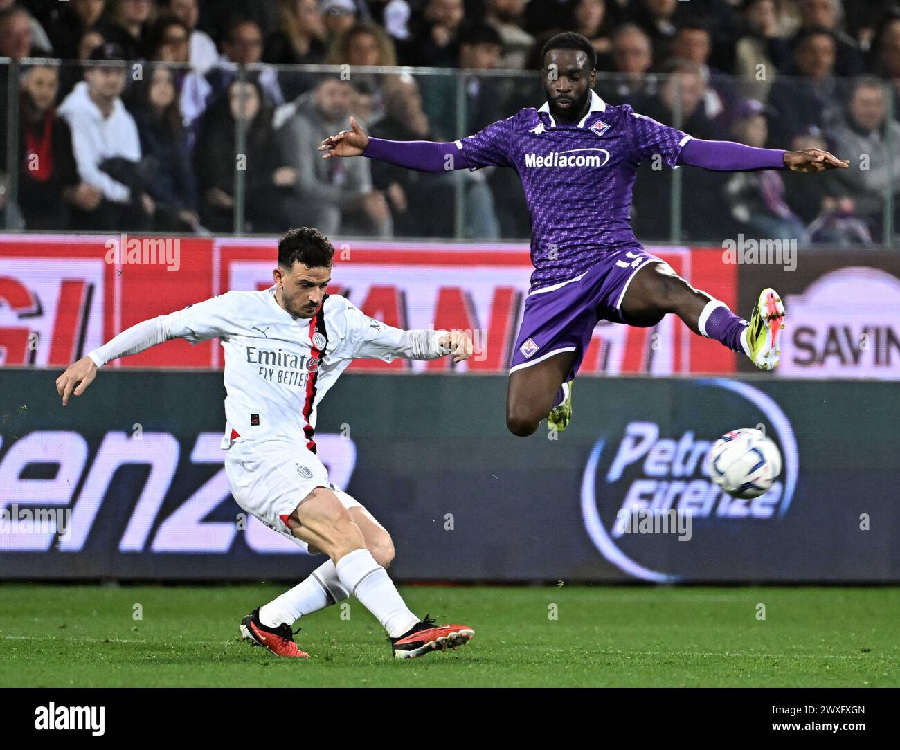 Florenz, Italien. 30. März 2024. Fiorentinas Jonathan Ikone (R) streitet mit Alessandro Florenzi des AC Mailand während eines Fußballspiels der Serie A in Florenz, Italien, am 30. März 2024. Quelle: Augusto Casasoli/Xinhua/Alamy Live News Stockfoto