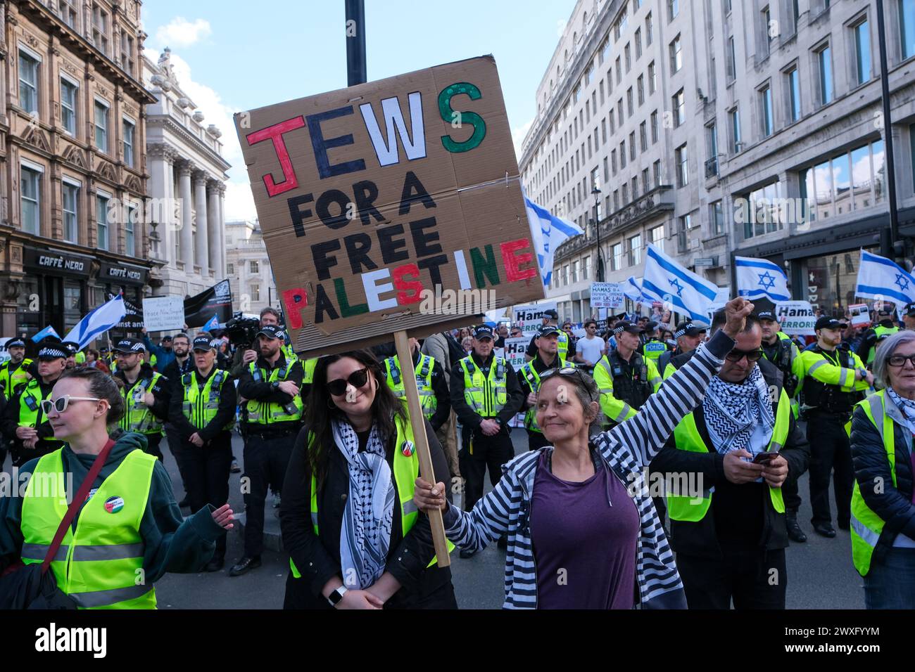 London, UK, 30. März 2024. Ein pro-palästinensischer jüdischer Demonstrant steht vor der israelischen Gegendemonstration entlang der Route des elften nationalen palästinensischen marsches. Die Gruppe trug die Nationalflagge und entführte Plakate, als sie die Freilassung von Geiseln forderten, die noch immer in Gaza festgehalten wurden. Quelle: Eleventh Photography/Alamy Live News Stockfoto