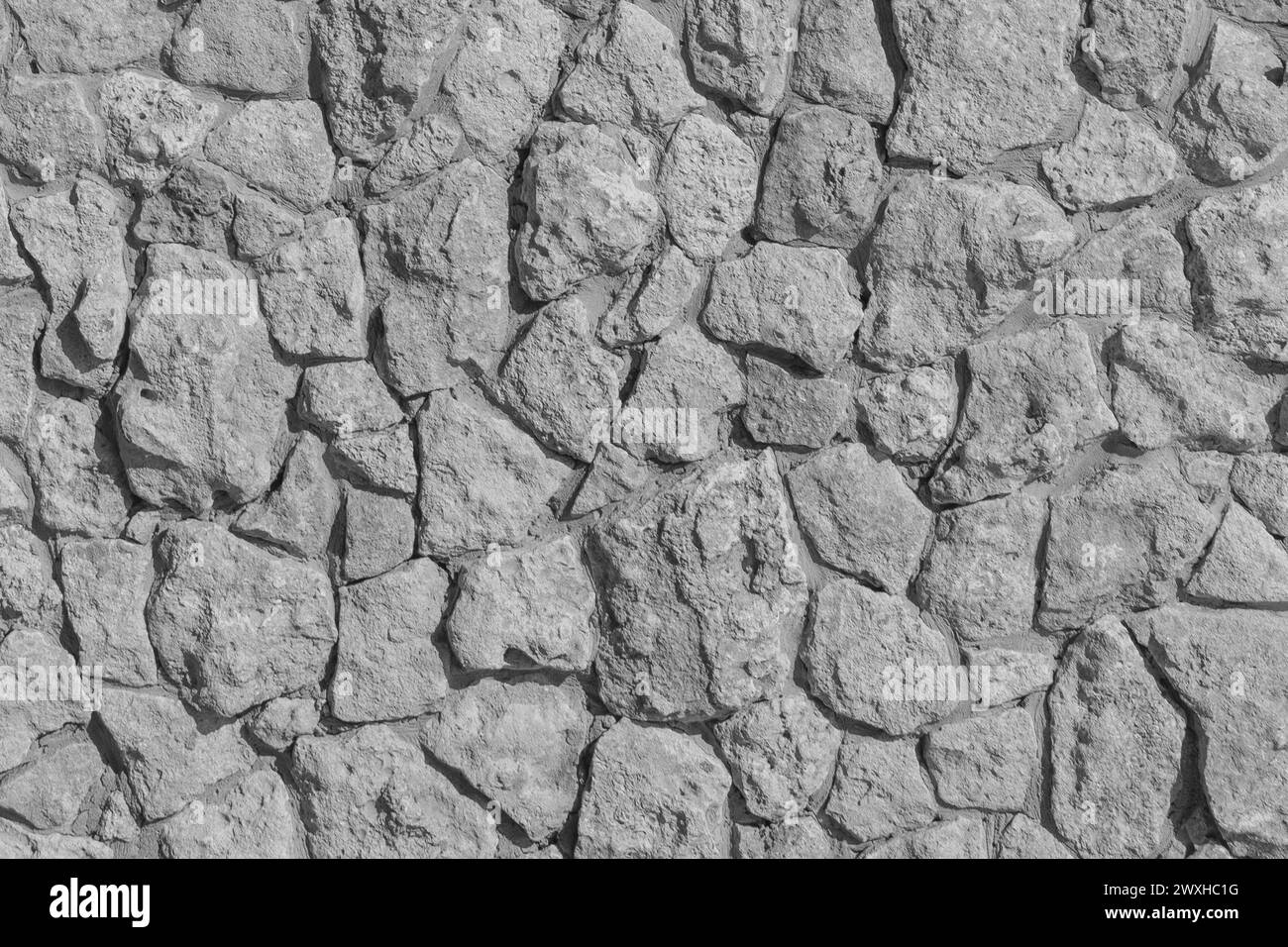 Grauer Stein Rough Abstraktes Muster Solid Wall Surface Texture Hintergrund Hardstructure Mosaik. Stockfoto