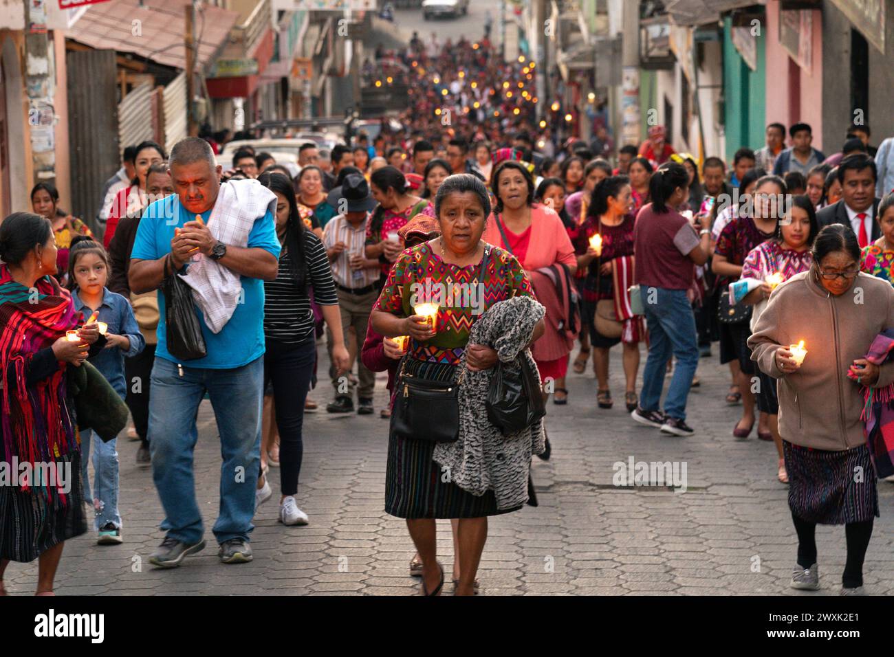 Chichicastenango, Guatemala. 30. März 2024. Indigene Maya-Frauen, die traditionelle Huipiles tragen, führen am Heiligen Samstag eine Kerzenlichtprozession, die christliche und Maya-Glaubenssätze miteinander verbindet, durch das Marktgebiet zur Iglesia de Santo Tomás, 30. März 2024 in Chichicastenango, Guatemala. Die katholische Kirche und die Maya-Glaubenssätze haben sich vor langer Zeit in den indigenen Regionen Guatemalas in einem Prozess gemischt, der Synkretismus genannt wird. Quelle: Richard Ellis/Richard Ellis/Alamy Live News Stockfoto