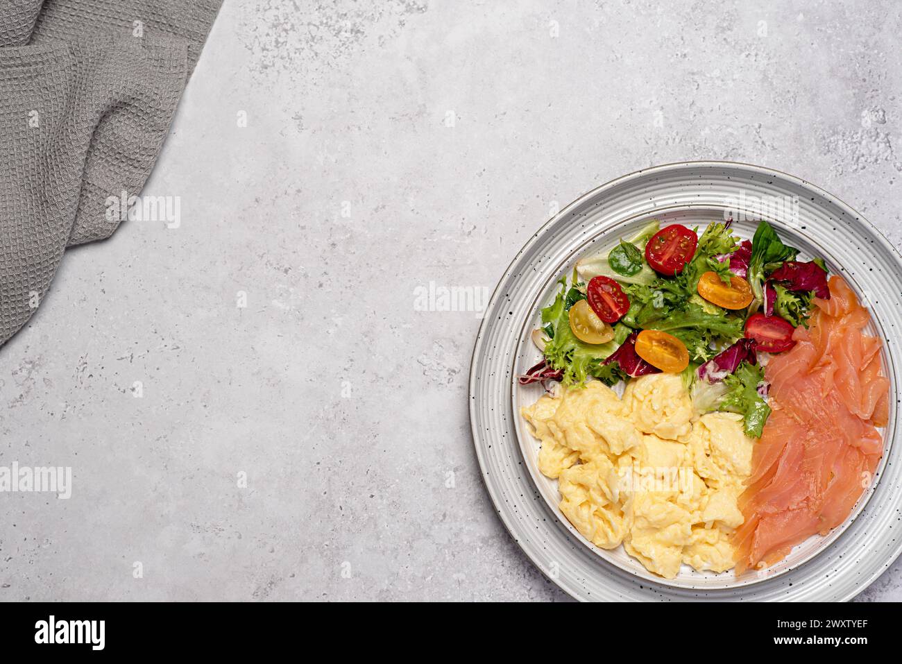 Blindaufnahmen von Rührei, Räucherlachs, Frühstück, Brunch, Omelette; Salat, Tomaten, Salat, Keto-Diät, Hintergrund Stockfoto