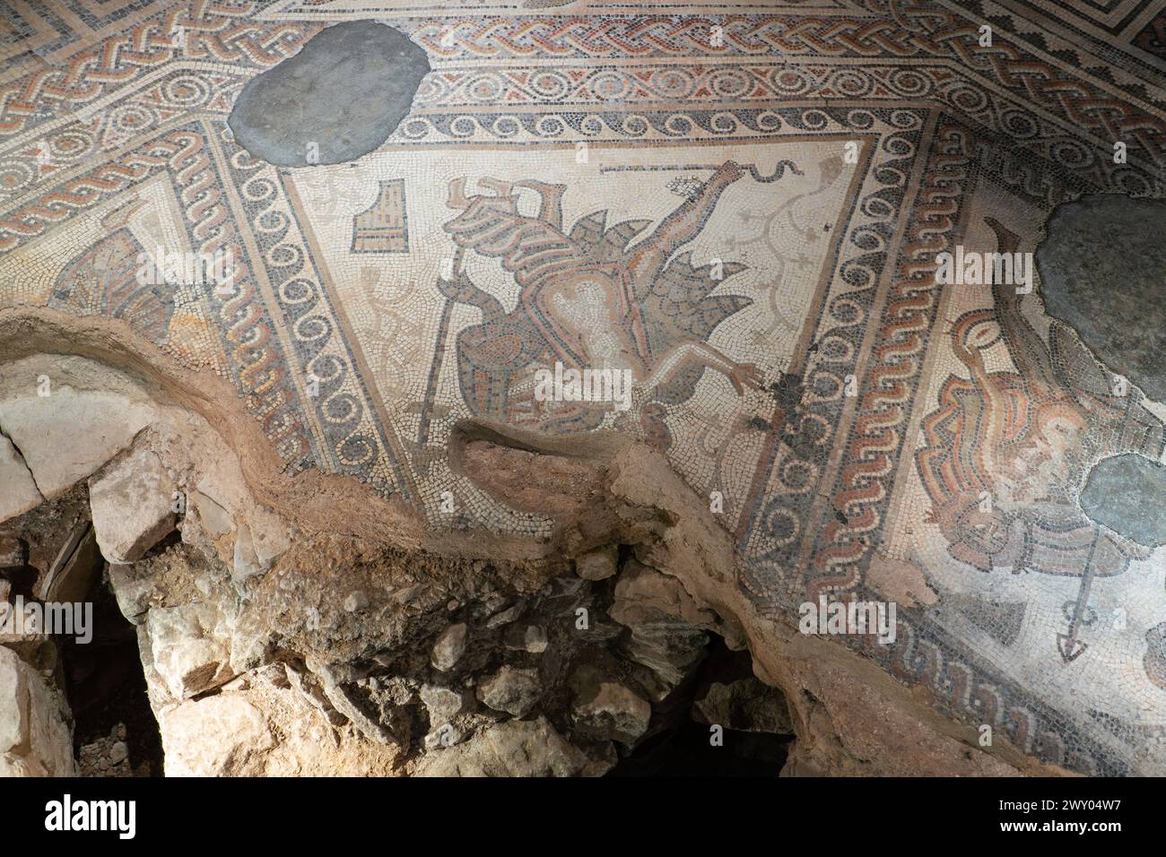 Das TriClinium (Speisesaal) im westlichen Bereich der Chedworth Roman Villa. Der Mosaikboden zeigt Mythen, die mit Bacchus, dem Gott des Weines, verbunden sind. UK Stockfoto
