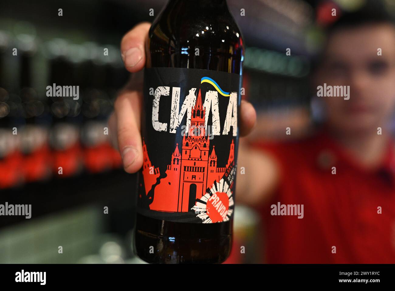 Lemberg, Ukraine - 2. April 2024: Ein Schuss lokales gebrautes Bier namens Power mit Etikett, das einen zerstörten Moskauer Kreml mit Flagge der Ukraine darstellt. Stockfoto