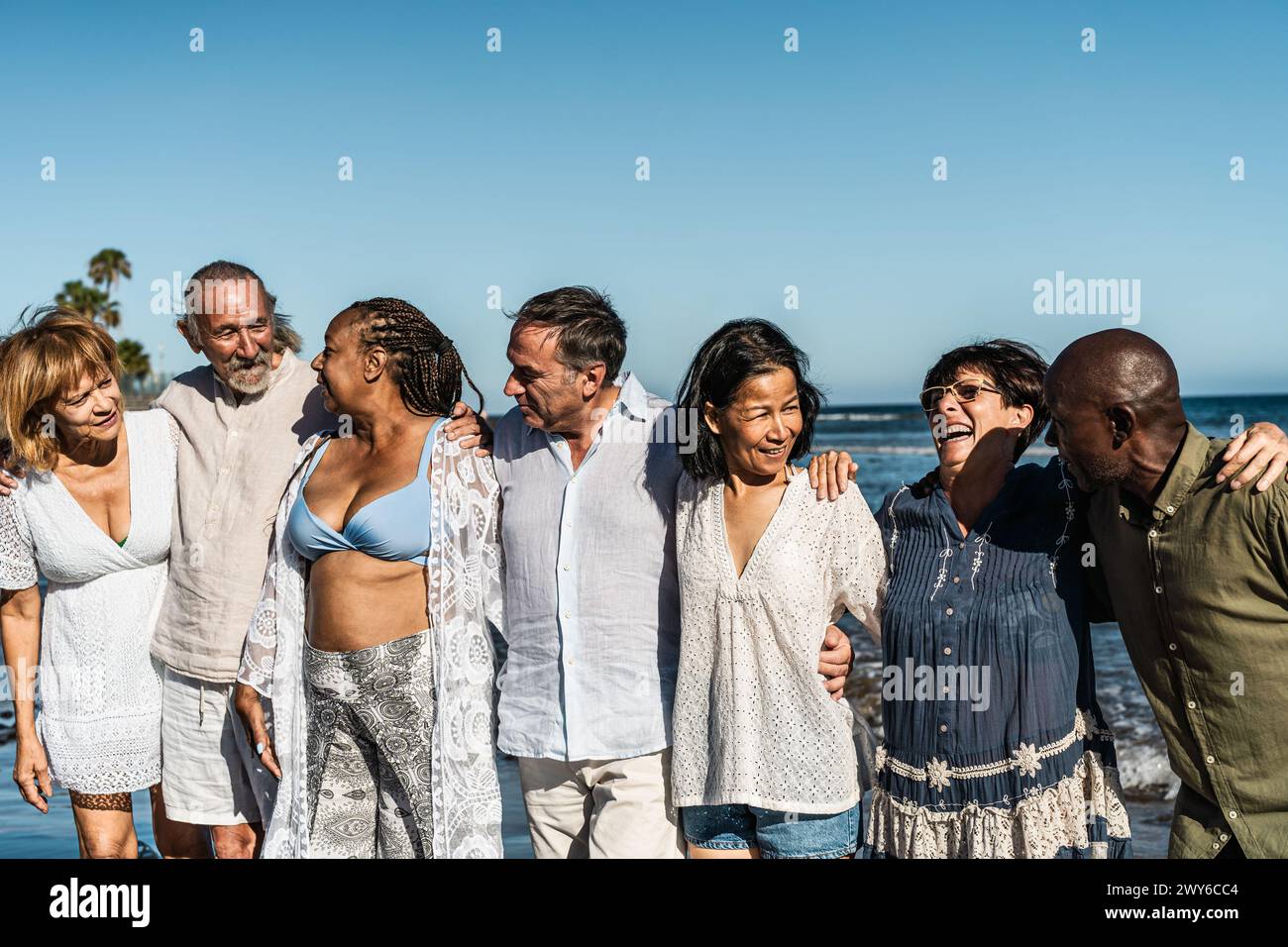 Fröhliche, multirassische Seniorenfreunde, die während der Sommerferien am Strand Spaß haben - verschiedene ältere Leute genießen den Urlaub Stockfoto