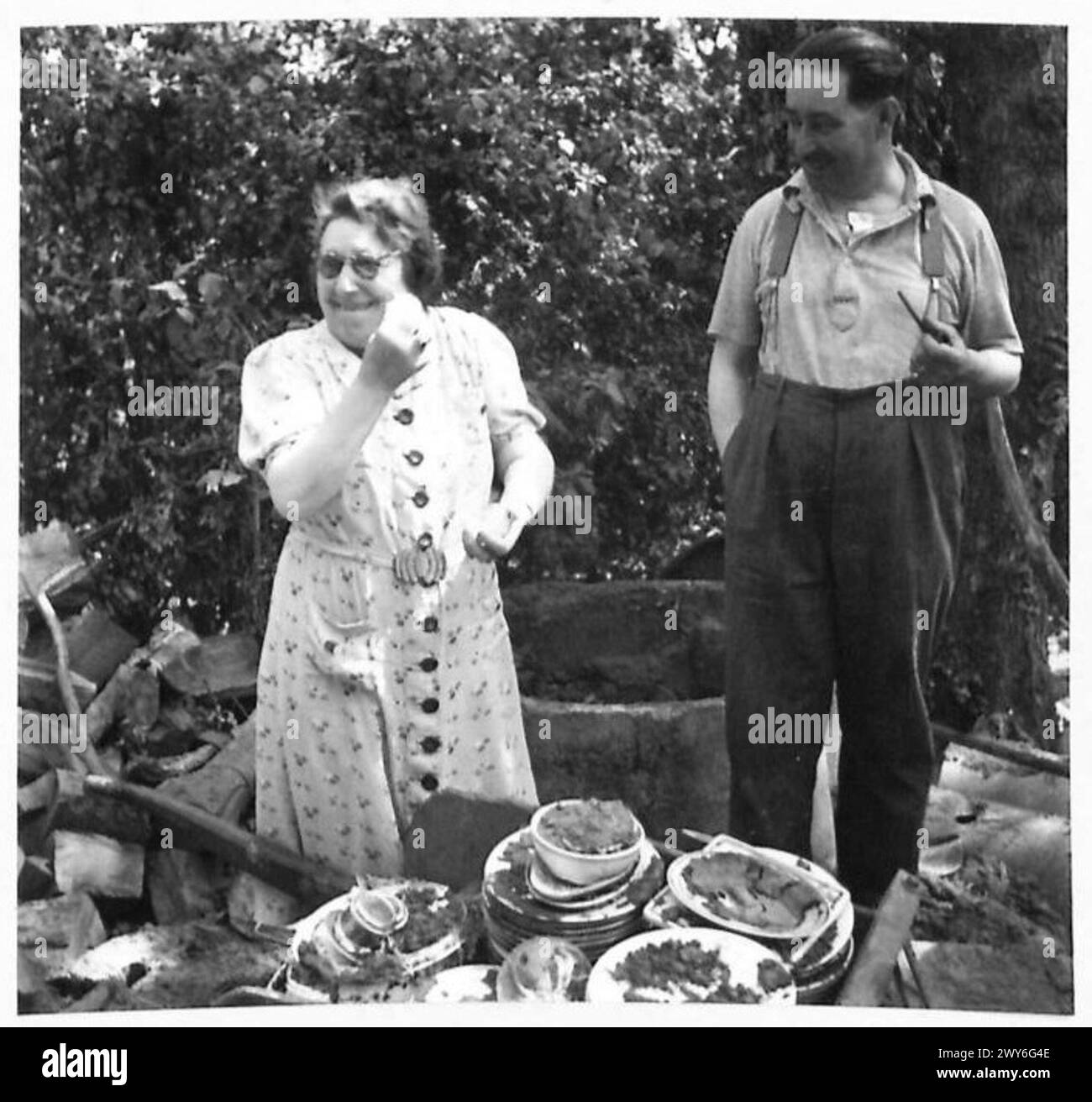 M. und Mme. Meyton sammelt Geschirr und Kochutensilien an einem versteckten Ort im Wald, nachdem er nach Hause zurückgekehrt ist. Stockfoto