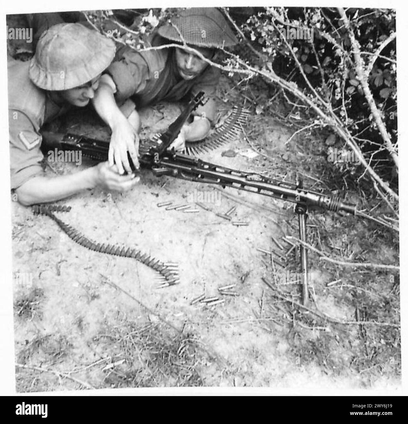 In einer Kampfschule der britischen Armee für potenzielle NCOs wird ein deutscher MG42-Maschinengewehrgürtel als Teil von Waffentraining-Übungen geladen. Stockfoto