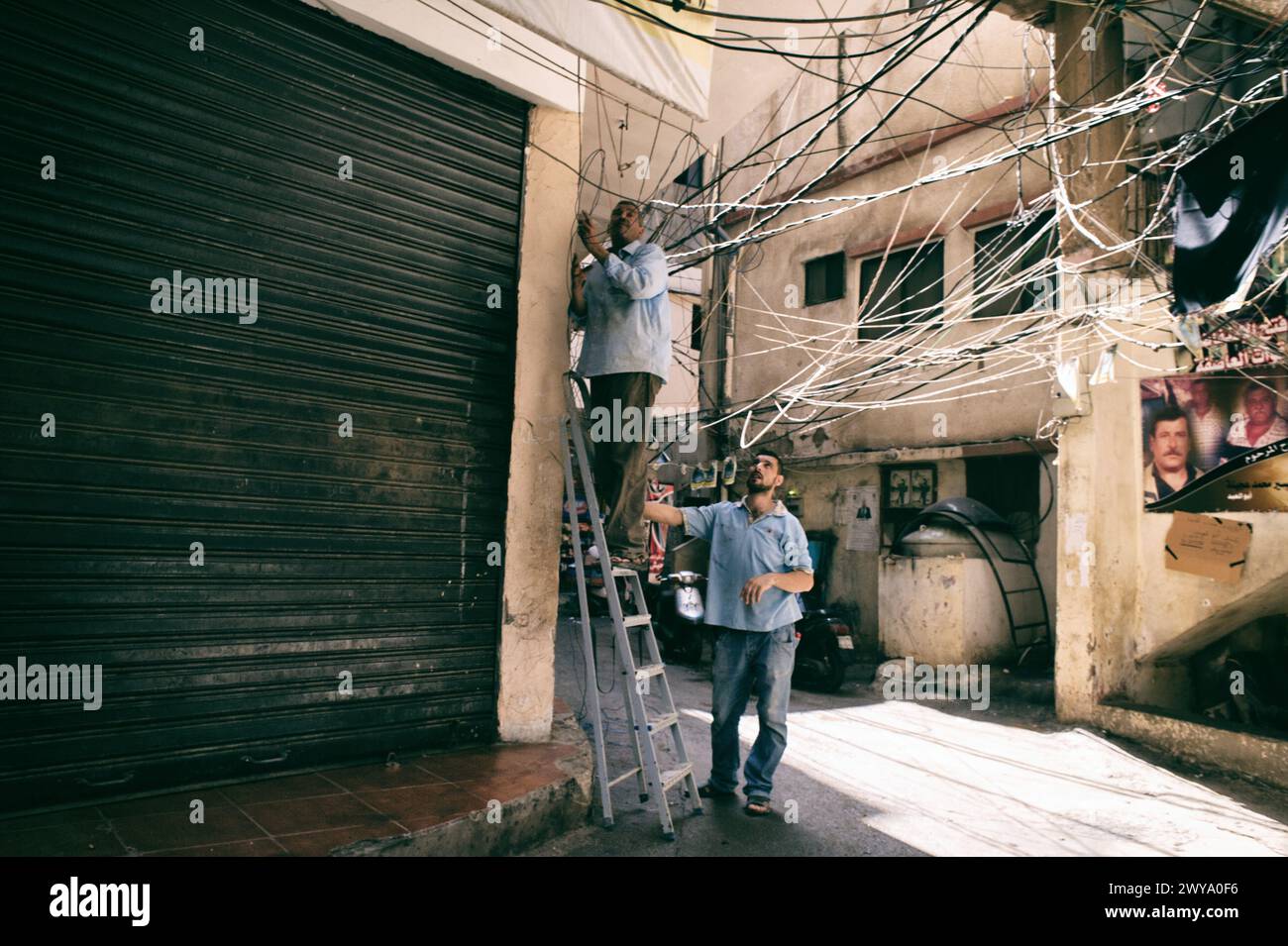 Elektriker arbeiten auf den Straßen des Flüchtlingslagers Sabra-Shatila im Libanon Stockfoto