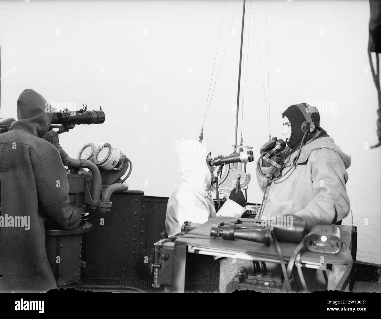 SZENEN AN BORD EINES SCHLACHTSCHIFFS AUF SEE. 1940 ODER 1941. - Ausblicke auf der Kontrollplattform eines von Großbritanniens riesigen Schlachtschiffen blicken durch die grauen Nebel des Winters. Die Kommunikationsnummer trägt Kopfhörer und meldet alles sichtbare. , Stockfoto