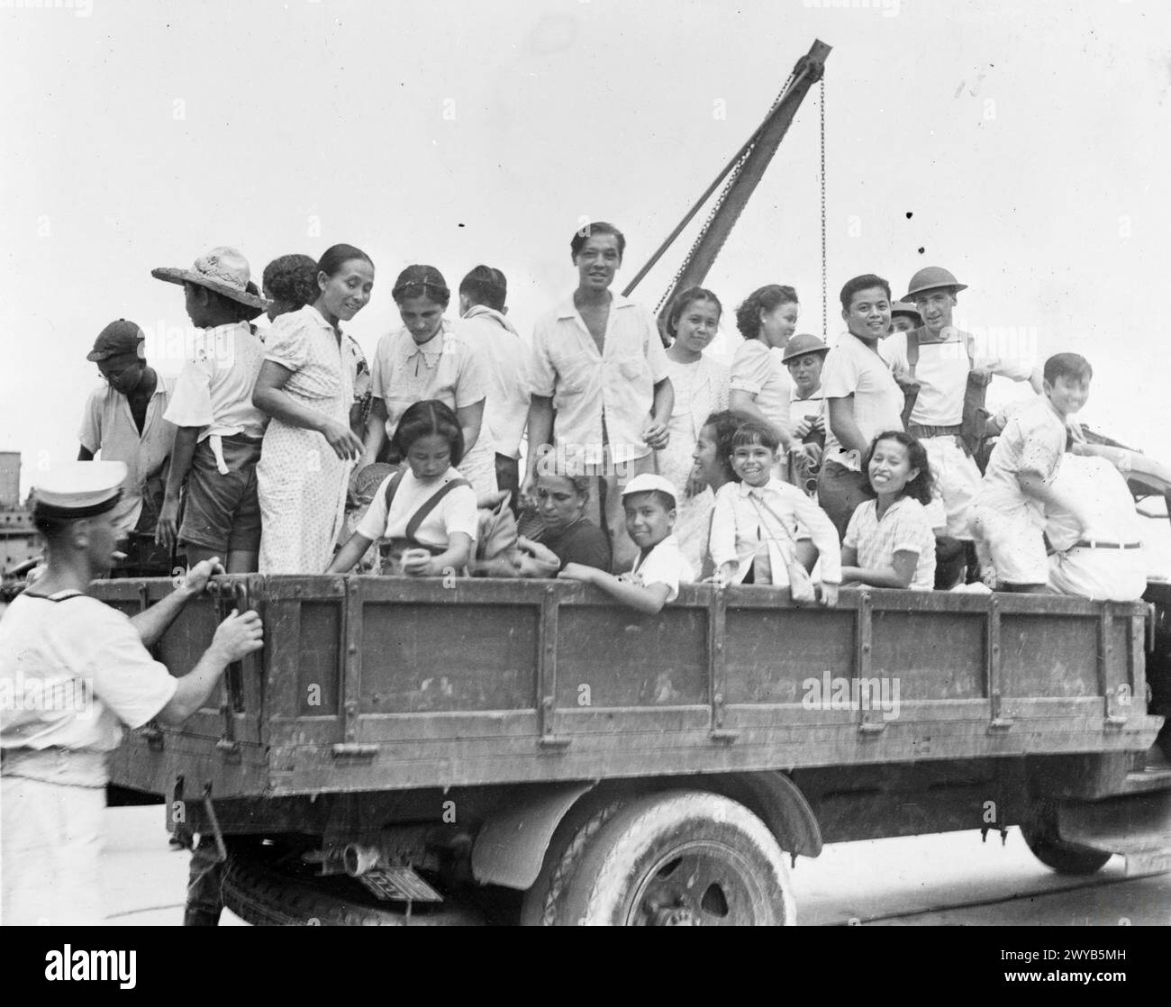 Nach der Wiederbesetzung Hongkongs am 30. August 1945 werden Internierte mit Lastwagen der Royal Navy in ein Rastlager transportiert. Stockfoto