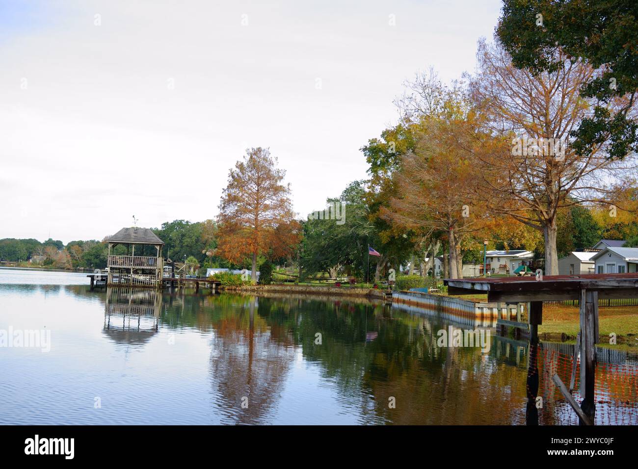 Herbstliche Ruhe am Crescent Lake in Brent, Pensacola, mit einem Pavillon, der sich am 4. Dezember 2024 im Wasser spiegelt. Stockfoto