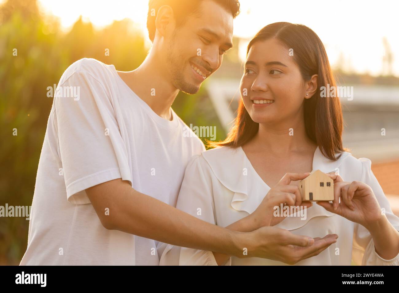 Leute Hand halten Miniatur Holz Haus Modell für Bank Wohnung Hypotheken Immobilien Miete Haus Familie Konzept Stockfoto