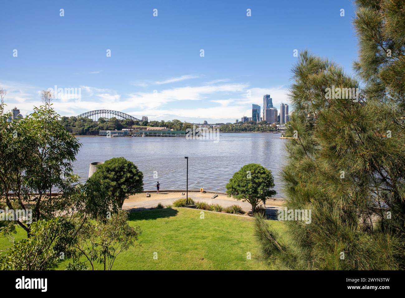Ballastpoint Park auf der Sydney Balmain Peninsula mit Blick über den Hafen zur Sydney Harbour Bridge, Goat Island und Wolkenkratzern im Stadtzentrum. Stockfoto