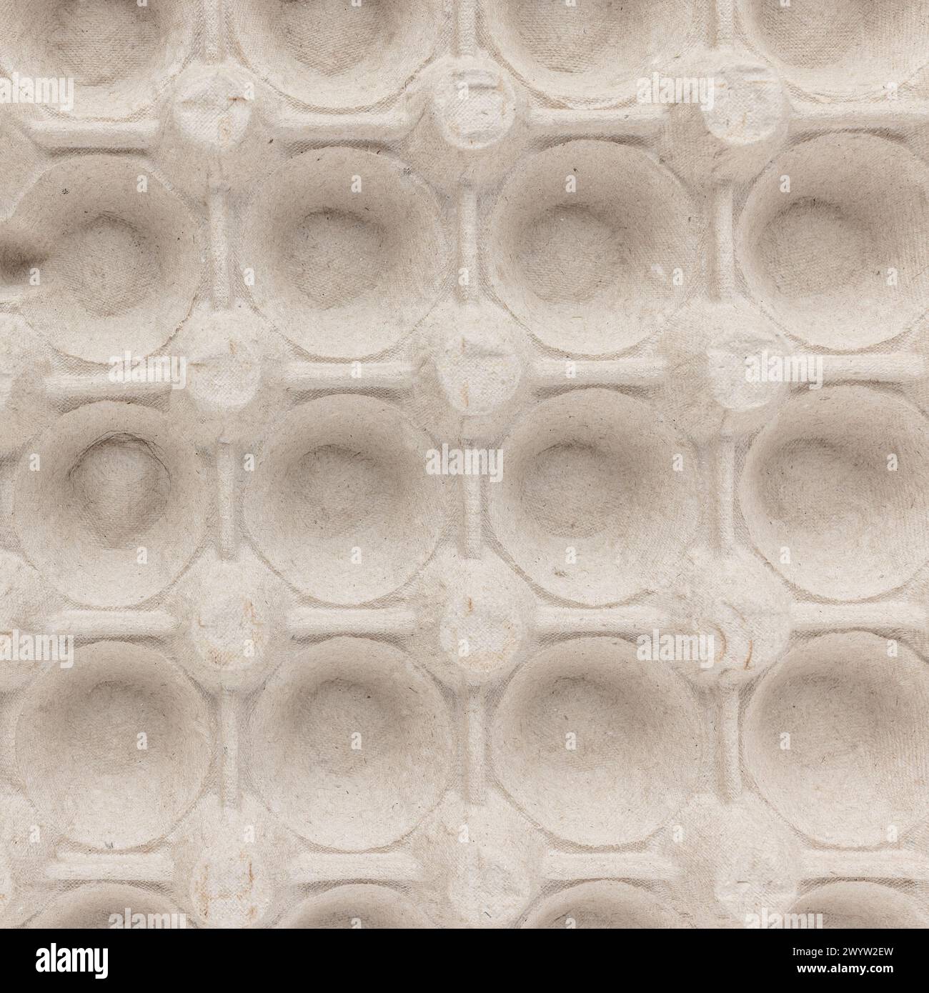 Draufsicht eines beigefarbenen Eierkartons mit symmetrischen kreisförmigen Einbuchtungen Stockfoto