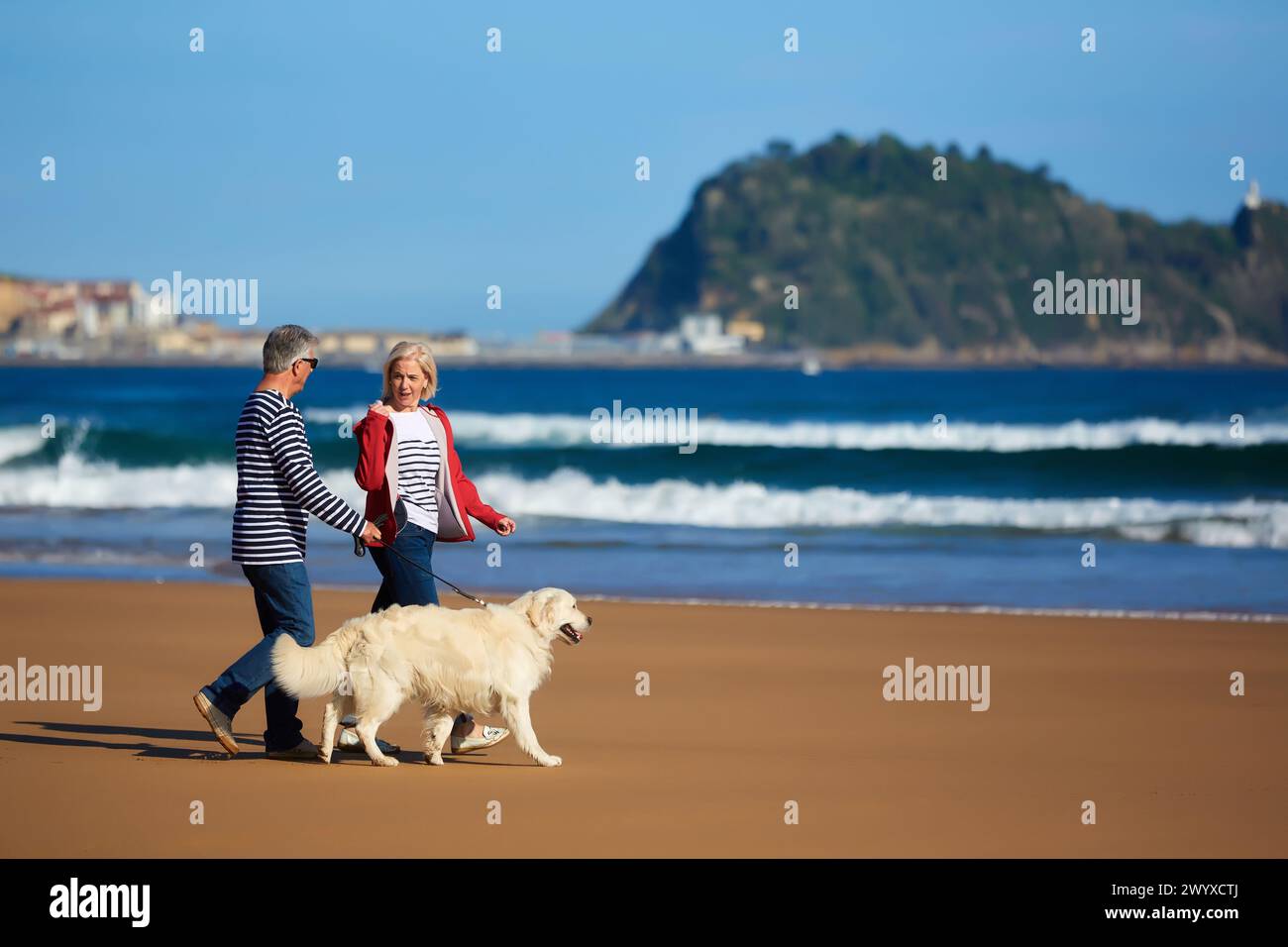 Seniorenpaar, 60-70, Spaziergang mit Hund am Strand, Hintergrund Getaria, Zarautz, Gipuzkoa, Baskenland, Spanien, Europa. Stockfoto