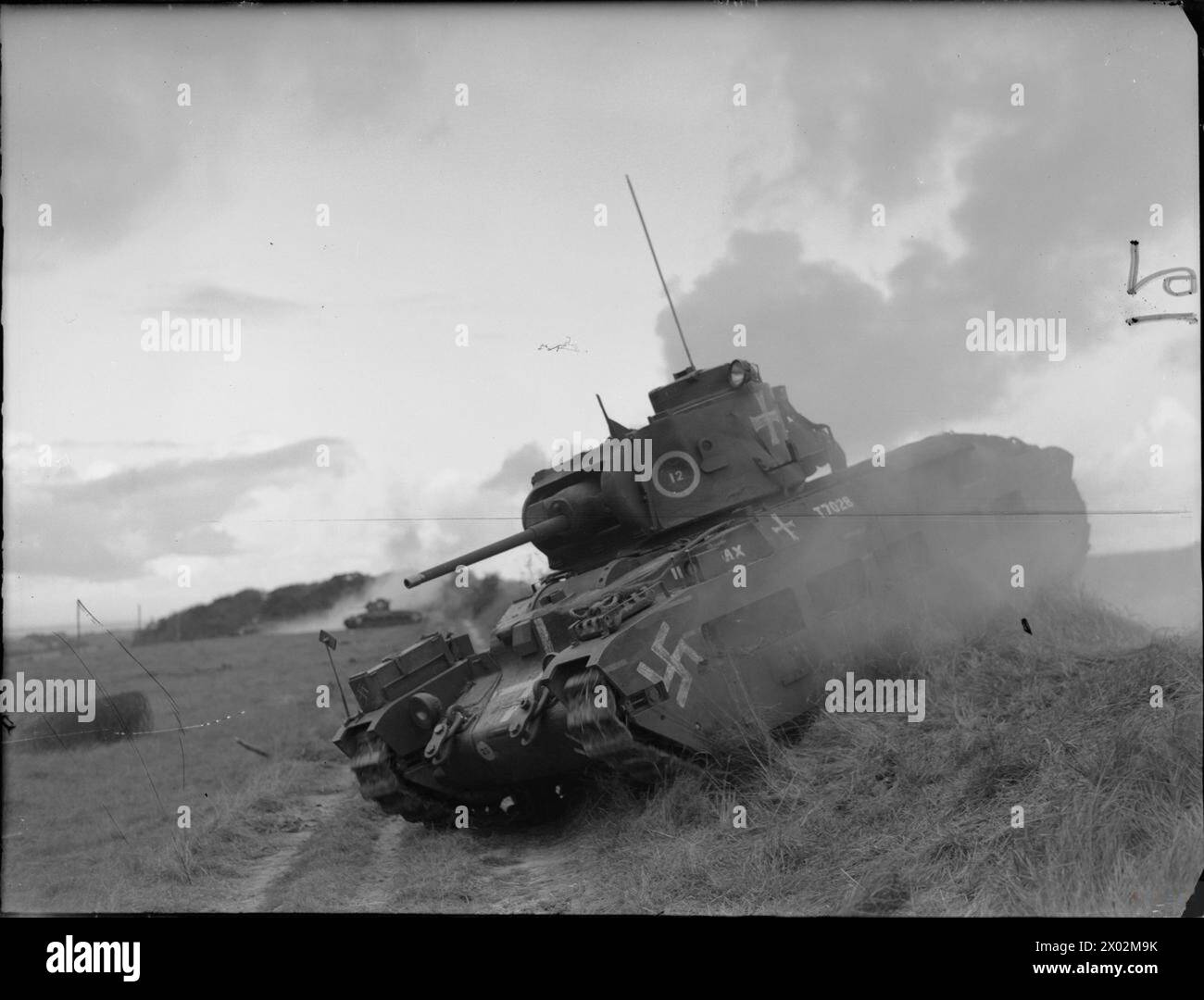 DIE BRITISCHE ARMEE IM VEREINIGTEN KÖNIGREICH 1939-45 – Ein Panzer der Matilda des 49. Royal Tank Regiment stürzt während einer Übung in der Nähe von Dover am 23. Oktober 1941 über raues Gelände. Das Fahrzeug ist mit Hakenkreuzen und Kreuzen versehen, um einen feindlichen Panzer der britischen Armee, 49. Royal Tank Regiment, zu repräsentieren Stockfoto