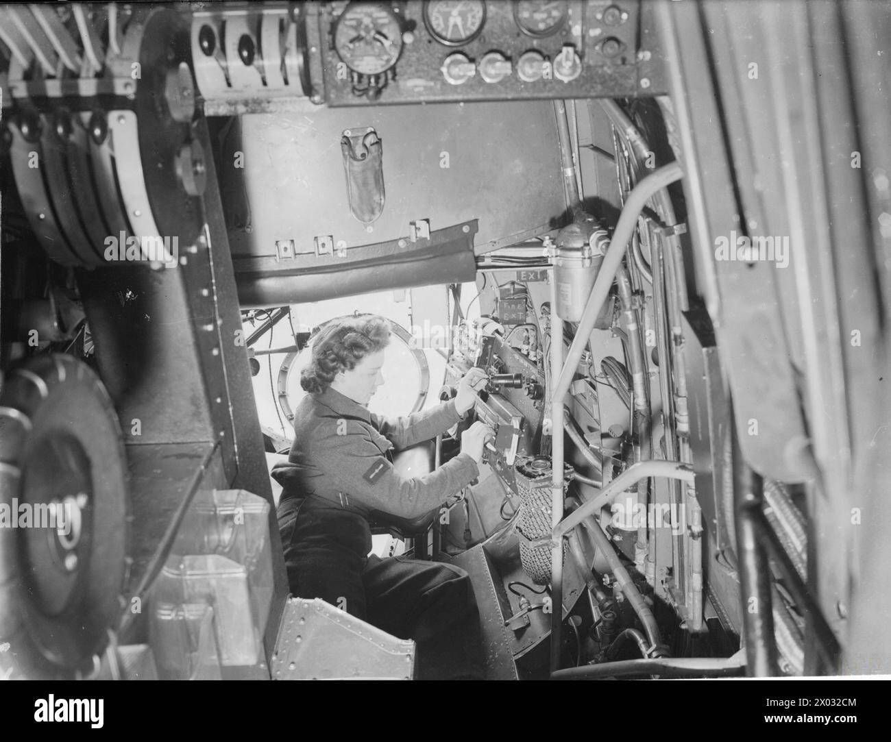 Ein Elektriker der Women's Auxiliary Air Force (WAAF) stellte während des Zweiten Weltkriegs Bombenschaltereinheiten an einem Lancaster-Bomber ein, um die Operationen der Royal Air Force zu unterstützen. Stockfoto