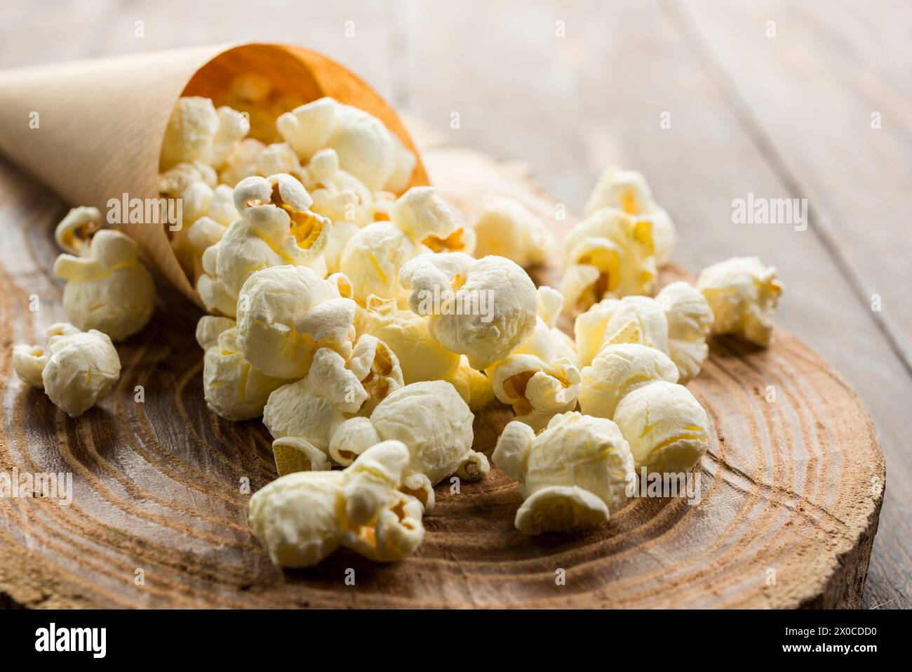 Nahaufnahme von gesalzenem Popcorn auf Holztisch. Stockfoto