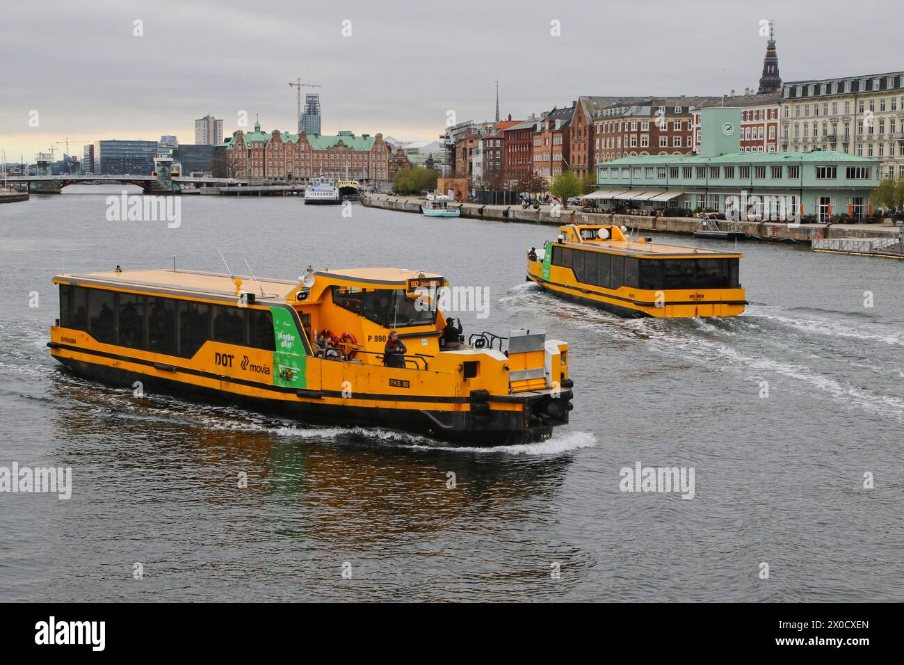 Zwei gelbe Bootsbusse fahren im Kopenhagener Hafen, Dänemark, April 2024 Stockfoto