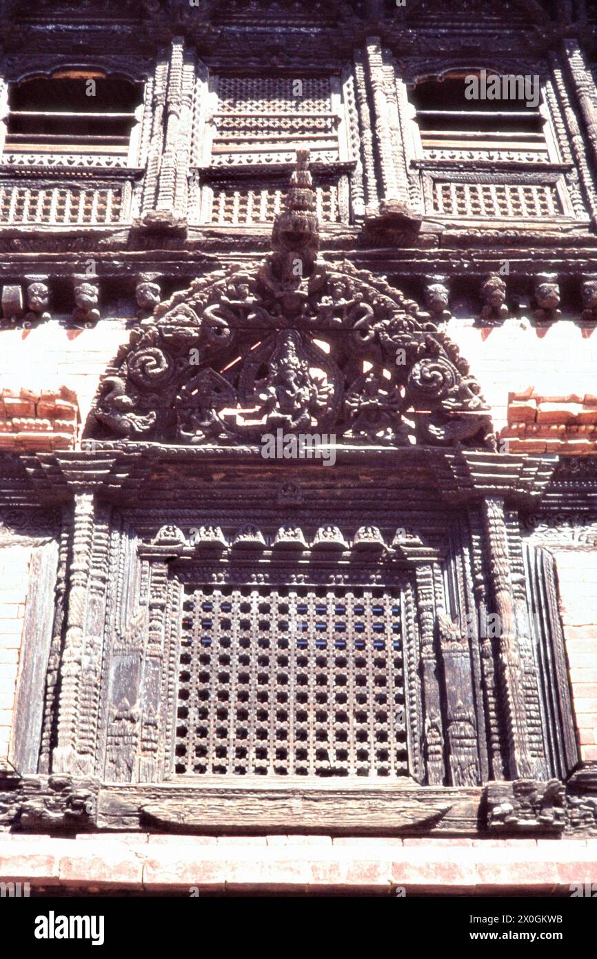 Holzgeschnitzte Fenster mit vielen Verzierungen im Königspalast in Bhaktapur. [Automatisierte Übersetzung] Stockfoto