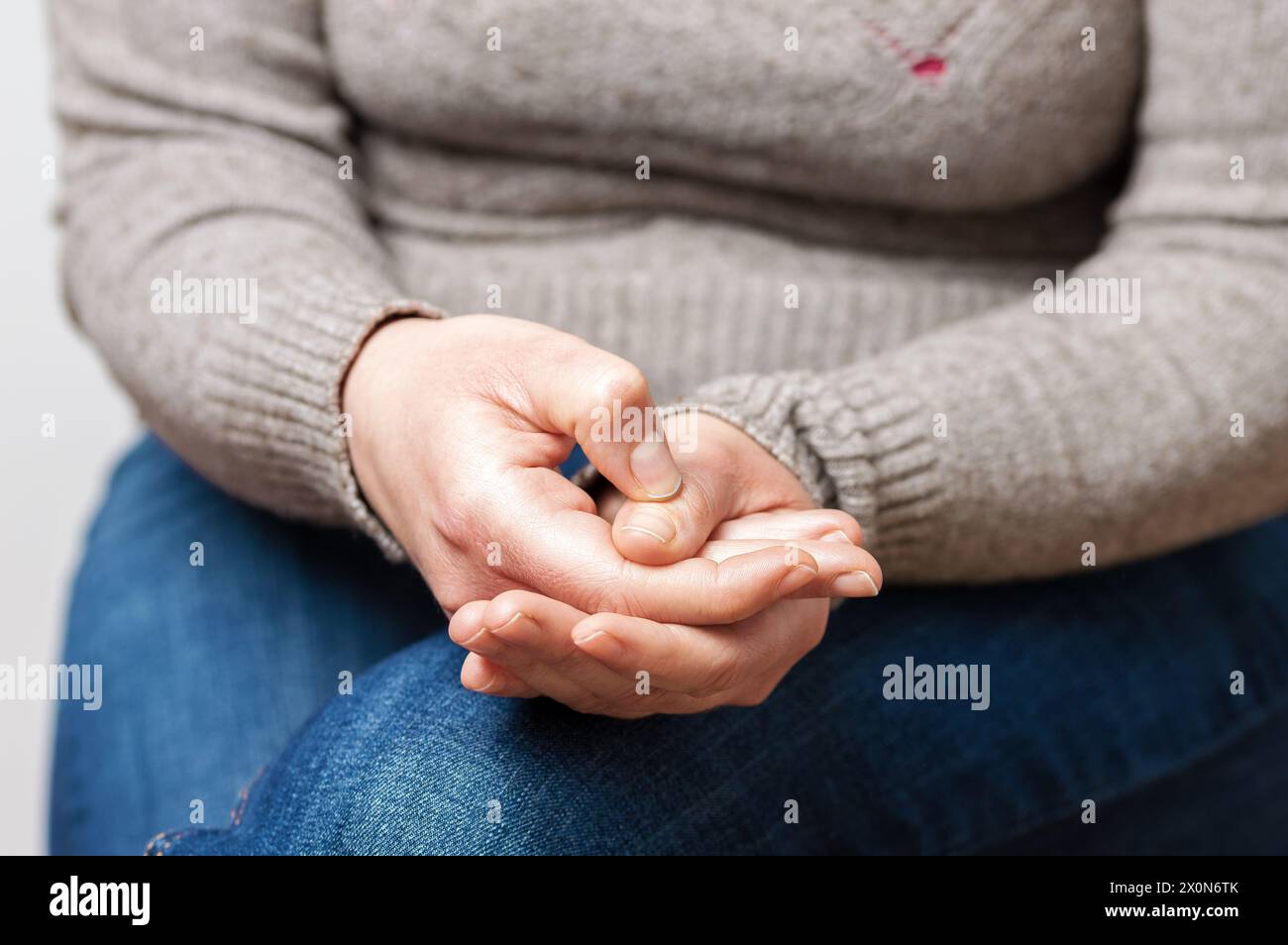 Kurze Aufnahme einer Frau, die auf dem Sofa sitzt und sich ängstlich fühlt Stockfoto