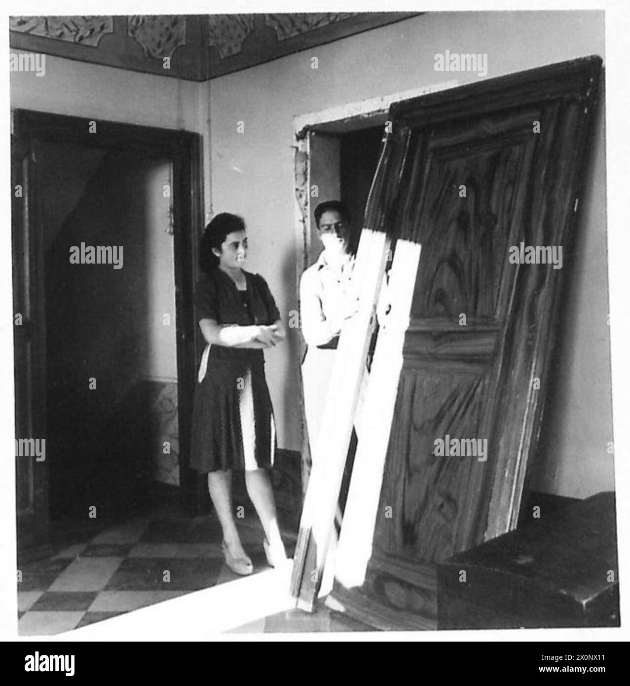 Die Deutschen entfernten gewaltsam eine verschlossene Tür, während sie ein Haus nach Wertsachen suchten. Signorina Katherina Monteferrante und ihr Bruder Antonio sind neben der beschädigten Tür abgebildet. Stockfoto