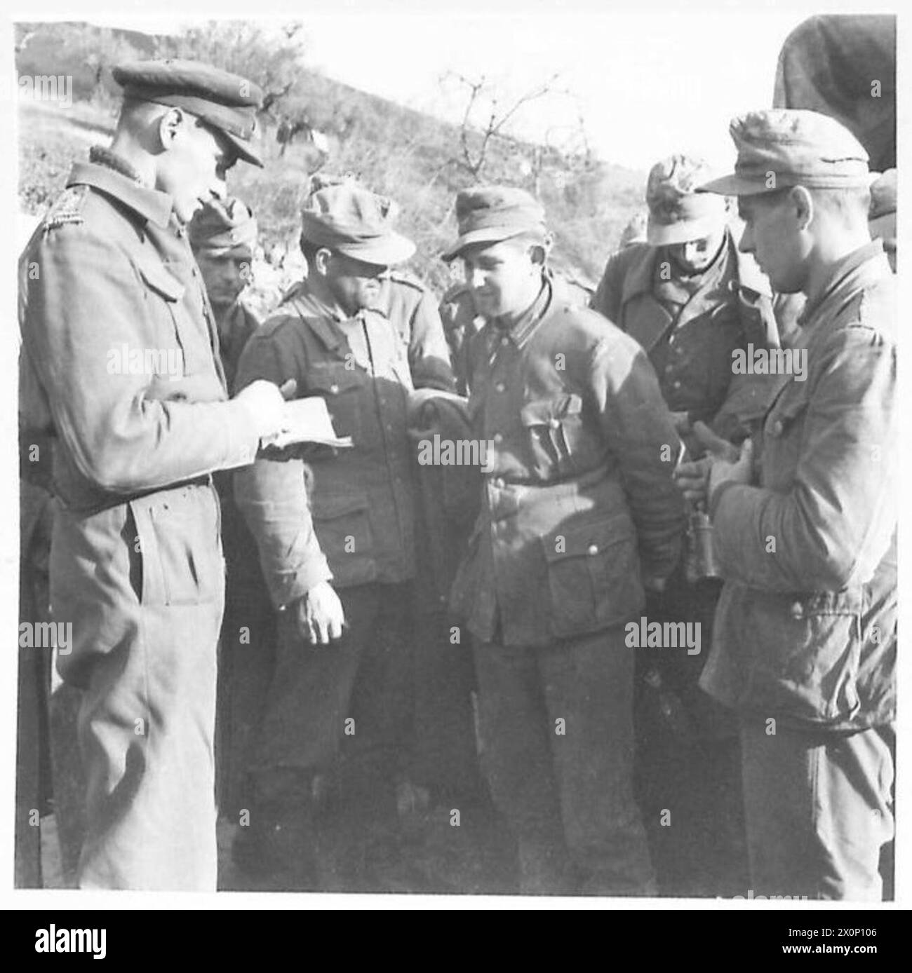 ITALIEN: ACHTE ARMYRIVER SANGRO SCHLACHT - nach dem ersten Angriff der neuseeländischen Division begannen die deutschen Gefangenen in unsere Linien zu kommen. Ein Teil der ersten Serie von 33 wird hier vom Geheimdienstoffizier der Division, Captain Castello, verhört. Einige dieser Gefangenen kämpften in Russland und hatten ihr russisches Wahlkampfband auf ihren Tuniken. Diese Charge wurde von Männern des 6. N.Z. Inf gefangen genommen. Bde Deren eigene Verluste sehr gering waren. Fotografisches negativ, britische Armee Stockfoto