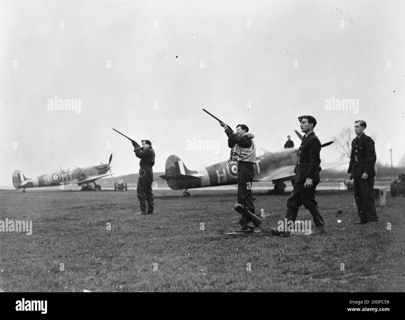 KÖNIGLICHE LUFTWAFFE, 1939-1945. - Piloten der No. 122 Squadron RAF, die Fallenschießen genießen, während sie sich zwischen den Einsätzen in Scorton, Yorkshire, entspannen. Der Schütze auf der linken Seite ist der Kommandeur der Geschwader, amtierender Anführer der Geschwader H J L Hallowes Royal Air Force, Royal Air Force Regiment, Sqdn, 122 Stockfoto