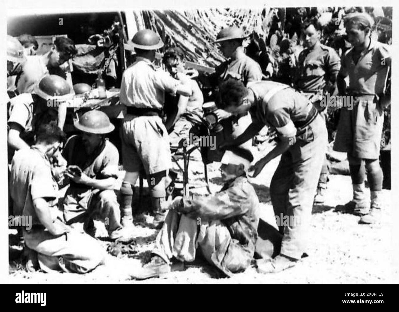 Scharfschützen des Herman Göring Regiments, die von den 5. Cameron Highlanders gefangen genommen wurden, werden vor dem Verhör während der Invasion von Sizilien in einem Regimental Aid Post medizinisch versorgt. Stockfoto